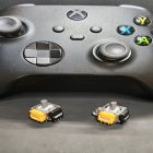 Xbox Series controller with two yellow analog stick replacements